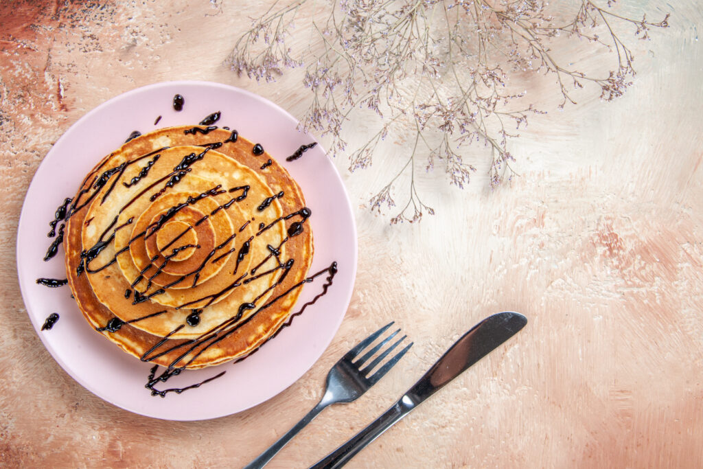 Fluffy homemade Cracker Barrel pancake stack with melted butter and maple syrup